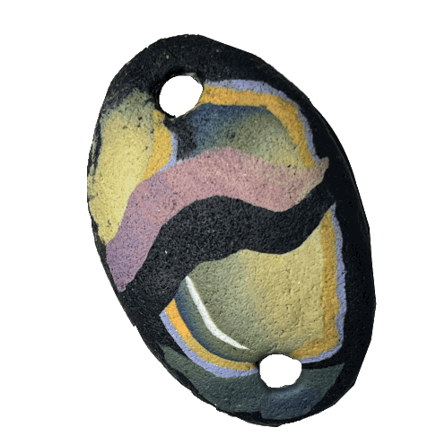 image of an oblong polymer clay pendant in black, blue, and mauve - like an 80s design