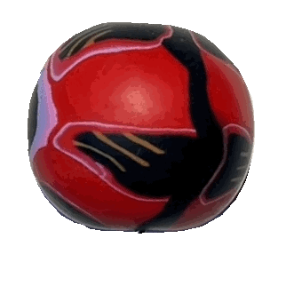 a red bead made from polymer clay with black, red, purple flowery shapes on it.