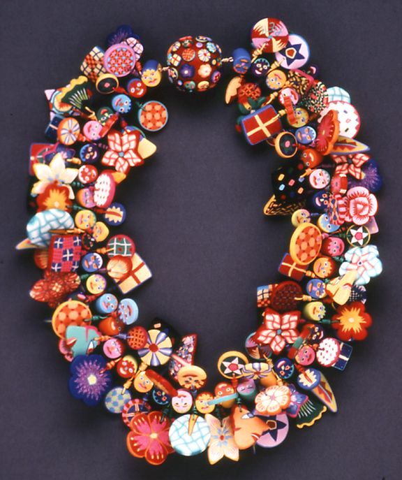 one of Voulkos' most famous works: a necklace featuring a massive cluster of face, checkered, and floral clay canes in all array of colors.
